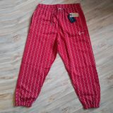 Melegíto nadrág Karl Kani Small Signature Ziczac Pinstripe Relaxed Fit Sweatpants dark red/off white